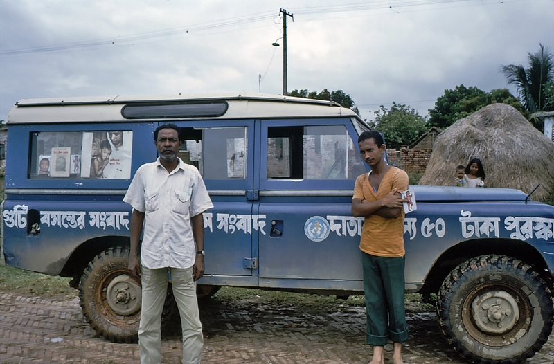 1975 Bangladesh. Driver, interpreter beside vehicle