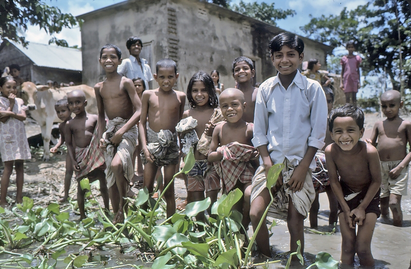 1975 Bangladesh. Villagers greet the team