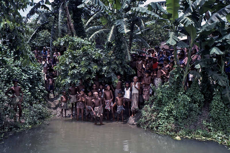 1975 Bangladesh. Villagers greet the team