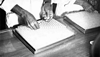 early 1970s Bangladesh. Inserting stoppers in vials